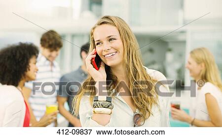 Woman talking on cell phone outdoors View Large Photo Image Stock Photo - Woman talking on cell phone outdoors. Fotosearch