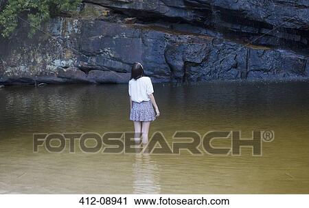 Woman wading and looking up in pool View Large Photo Image Stock Image - Woman wading and looking up in pool. Fotosearch