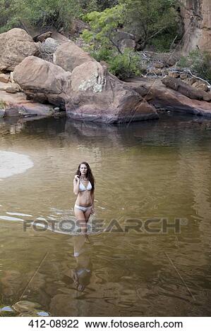 Stock Image - Woman wading in pool. Fotosearch