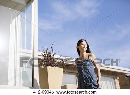 Woman walking outside modern house View Large Photo Image Stock Photography - Woman walking outside modern house. Fotosearch