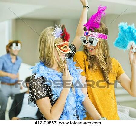 Women wearing decorative glasses and headpieces at party View Large Photo Image Stock Photo - Women wearing decorative glasses and headpieces at party. Fotosearch