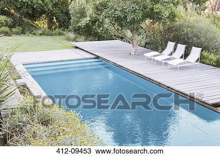 Wooden Deck And Lounge Chairs By Swimming Pool Stock Image 412