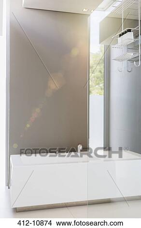 Bathtub and glass wall in modern bathroom View Large Photo Image Picture - Bathtub and glass wall in modern bathroom. Fotosearch