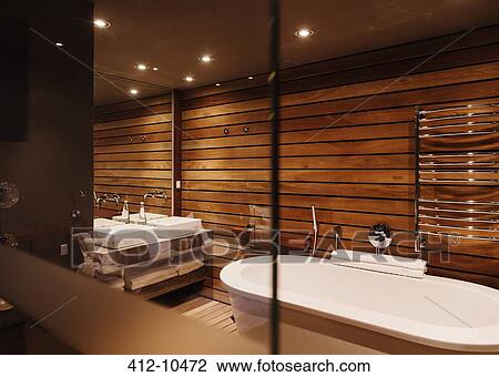 Stock Image - Bathtub and sinks in modern bathroom. Fotosearch