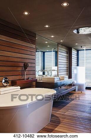 Stock Image - Bathtub and sinks in modern bathroom. Fotosearch