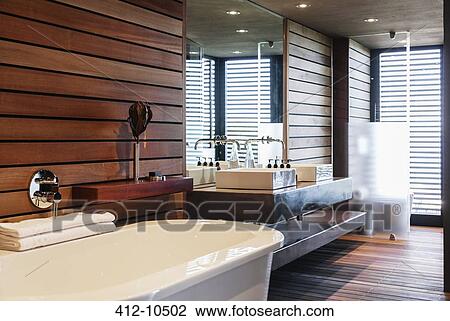 Stock Image - Bathtub and sinks in modern bathroom. Fotosearch