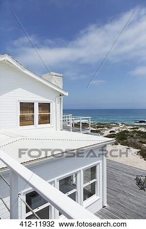 Stock Image - Beach house overlooking ocean. Fotosearch