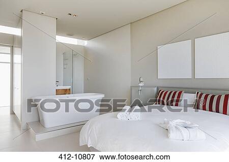 Bed and bathtub in modern bedroom View Large Photo Image Stock Photo - Bed and bathtub in modern bedroom. Fotosearch