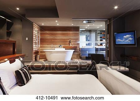 Bed and bathtub in modern master bedroom View Large Photo Image Stock Image - Bed and bathtub in modern master bedroom. Fotosearch