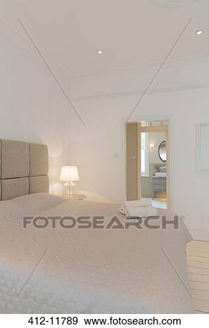 Stock Photo - Bed and towels in modern bedroom. Fotosearch