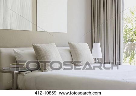 Bed in modern bedroom View Large Photo Image Stock Photo - Bed in modern bedroom. Fotosearch