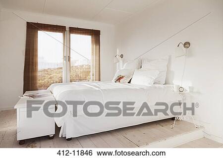 Bed in white bedroom View Large Photo Image Stock Photograph - Bed in white bedroom. Fotosearch
