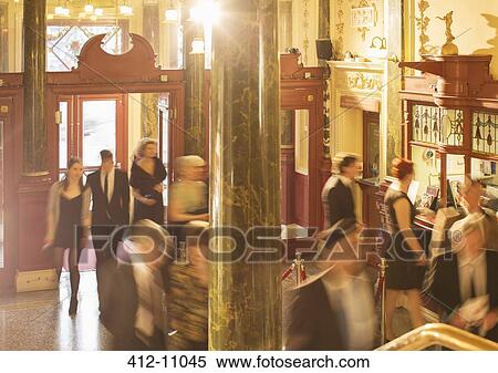 Blurred motion of people in theater lobby View Large Photo Image Stock Photography - Blurred motion of people in theater lobby. Fotosearch