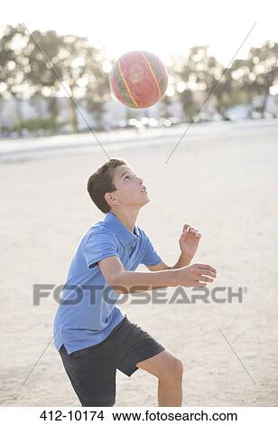 Boy heading soccer ball View Large Photo Image Picture - Boy heading soccer ball. Fotosearch