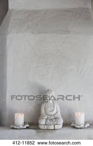 Buddha figurine and candles on ledge View Large Photo Image Stock Image - Buddha figurine and candles on ledge. Fotosearch