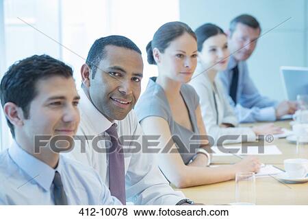Business people smiling in meeting View Large Photo Image Stock Photo - Business people smiling in meeting. Fotosearch
