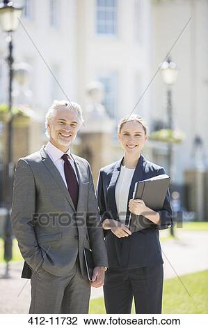 Business people smiling on city street View Large Photo Image Stock Image - Business people smiling on city street. Fotosearch