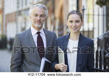 Business people smiling on urban sidewalk View Large Photo Image Picture - Business people smiling on urban sidewalk. Fotosearch