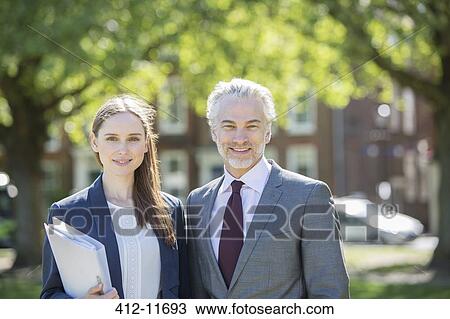Stock Image - Business people smiling outdoors. Fotosearch