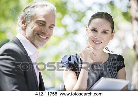 Business people smiling outdoors View Large Photo Image Stock Photo - Business people smiling outdoors. Fotosearch