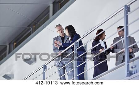 Business people talking at railing n office View Large Photo Image Stock Image - Business people talking at railing n office. Fotosearch