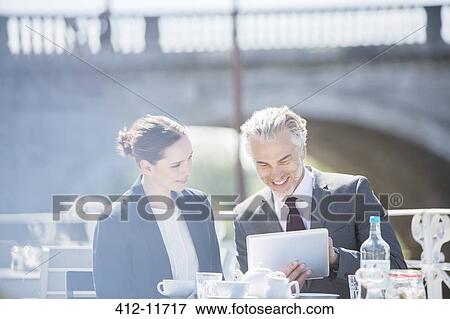 Business people talking at sidewalk cafe View Large Photo Image Stock Photo - Business people talking at sidewalk cafe. Fotosearch