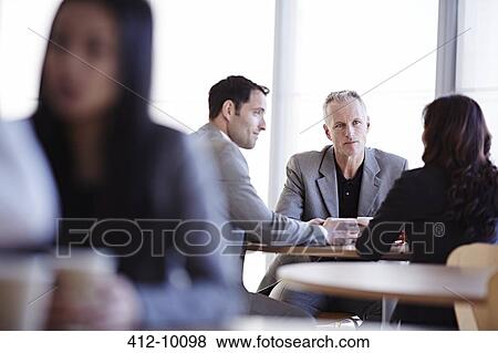 Business people talking in cafe View Large Photo Image Stock Photo - Business people talking in cafe. Fotosearch