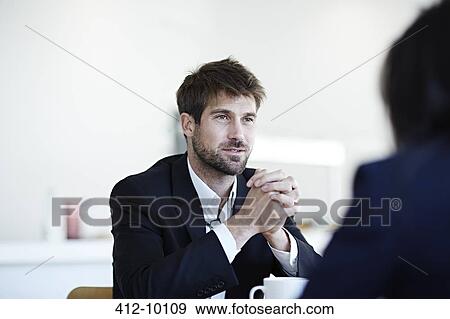 Stock Photo - Business people talking in cafe. Fotosearch