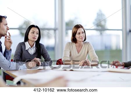 Stock Image - Business people talking in meeting. Fotosearch