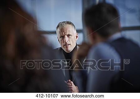 Stock Photo - Business people talking in meeting. Fotosearch