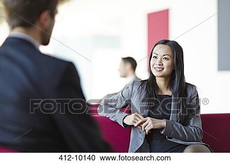 Business people talking in office lobby View Large Photo Image Stock Image - Business people talking in office lobby. Fotosearch