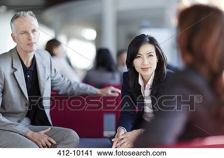 Business people talking in office lobby View Large Photo Image Stock Image - Business people talking in office lobby. Fotosearch