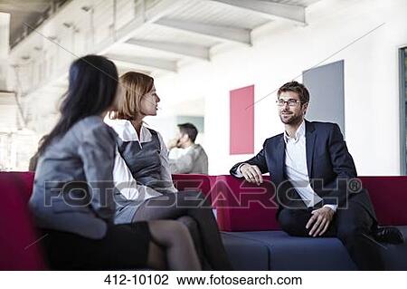 Stock Image - Business people talking in office. Fotosearch