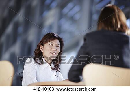 Stock Image - Business people talking in office. Fotosearch
