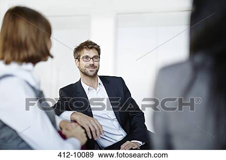 Stock Photo - Business people talking in office. Fotosearch