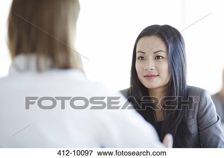 Business people talking in office View Large Photo Image Stock Photo - Business people talking in office. Fotosearch