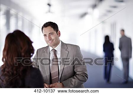 Business people talking in office corridor View Large Photo Image Stock Photo - Business people talking in office corridor. Fotosearch
