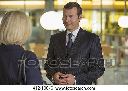 Business people talking in office View Large Photo Image Stock Photograph - Business people talking in office. Fotosearch