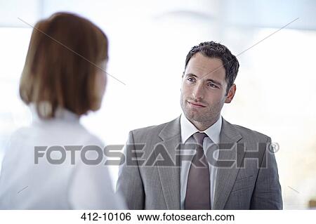 Business people talking in office View Large Photo Image Stock Photograph - Business people talking in office. Fotosearch