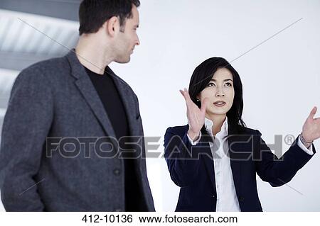 Business people talking in office View Large Photo Image Stock Photograph - Business people talking in office. Fotosearch
