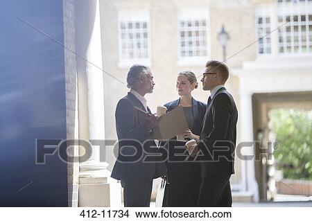 Business people talking on city street View Large Photo Image Picture - Business people talking on city street. Fotosearch