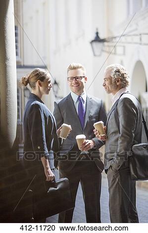 Stock Image - Business people talking on city street. Fotosearch