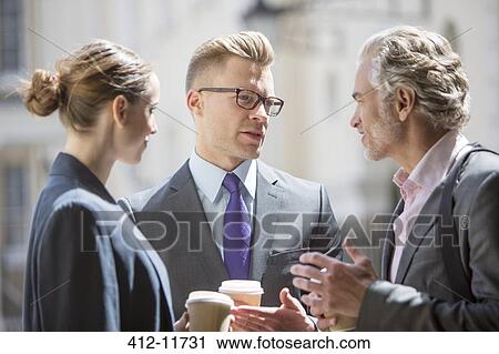 Business people talking on city street View Large Photo Image Stock Image - Business people talking on city street. Fotosearch