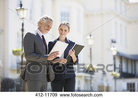Business people talking on city street View Large Photo Image Stock Photo - Business people talking on city street. Fotosearch
