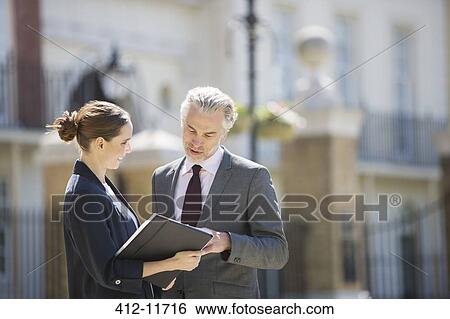 Business people talking outdoors View Large Photo Image Stock Photograph - Business people talking outdoors. Fotosearch