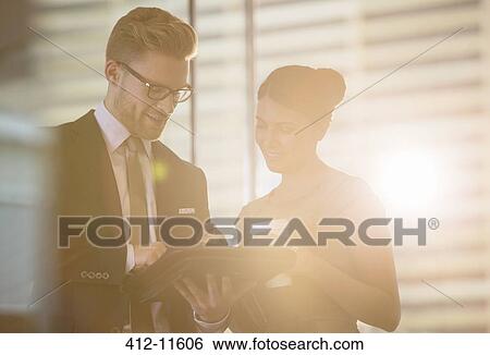 Business people using digital tablet in office View Large Photo Image Stock Photograph - Business people using digital tablet in office. Fotosearch