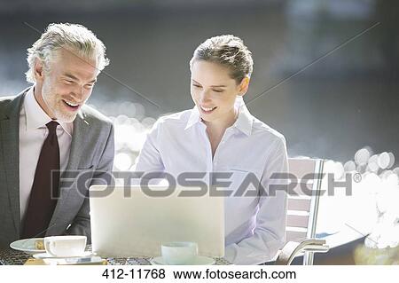 Stock Photo - Business people working at sidewalk cafe. Fotosearch