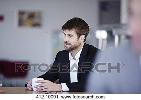 Businessman drinking coffee in cafe View Large Photo Image Stock Image - Businessman drinking coffee in cafe. Fotosearch