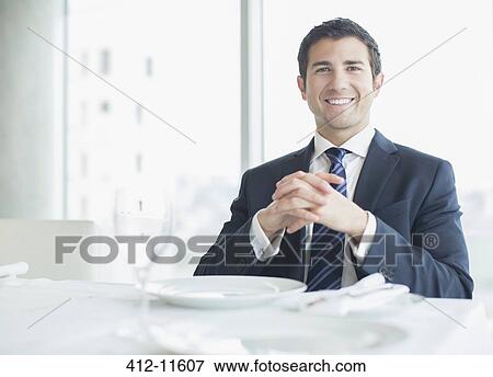 Stock Photo - Businessman smiling in restaurant. Fotosearch