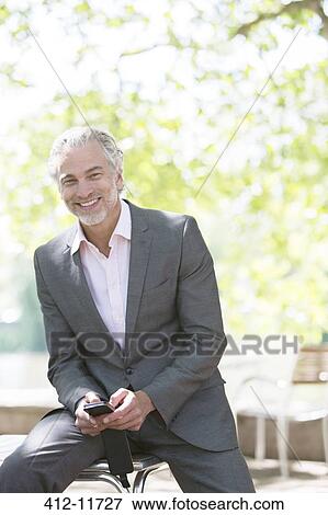 Stock Photo - Businessman smiling outdoors. Fotosearch